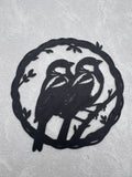 Two birds sitting on branch inside olive branch circle