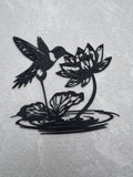 Hummingbird drinking from Flower over water